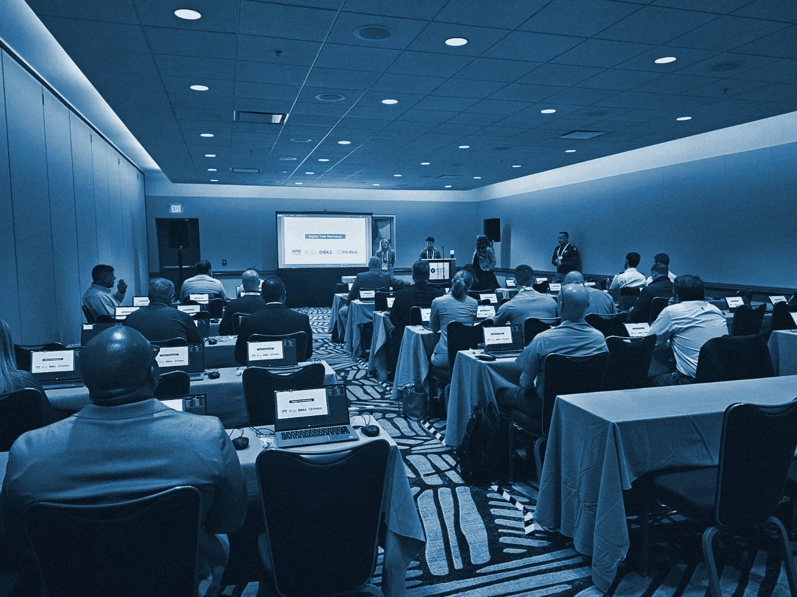 A full workshop room at I/ITSEC 2024, every attendee working on a laptop