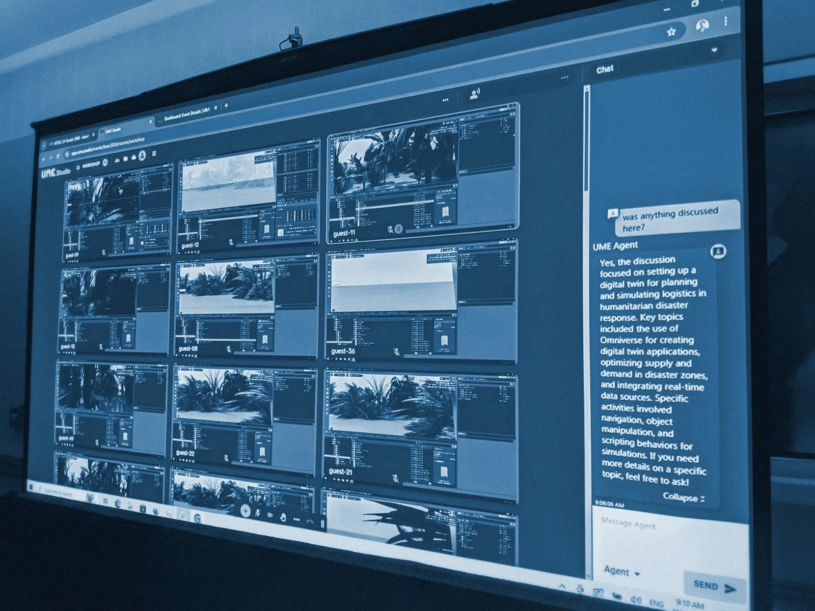 The UME.Studio instructor wall projected in a workshop room, with the UME Agent panel open