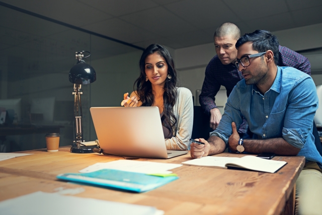 A cross-functional team working through a problem together